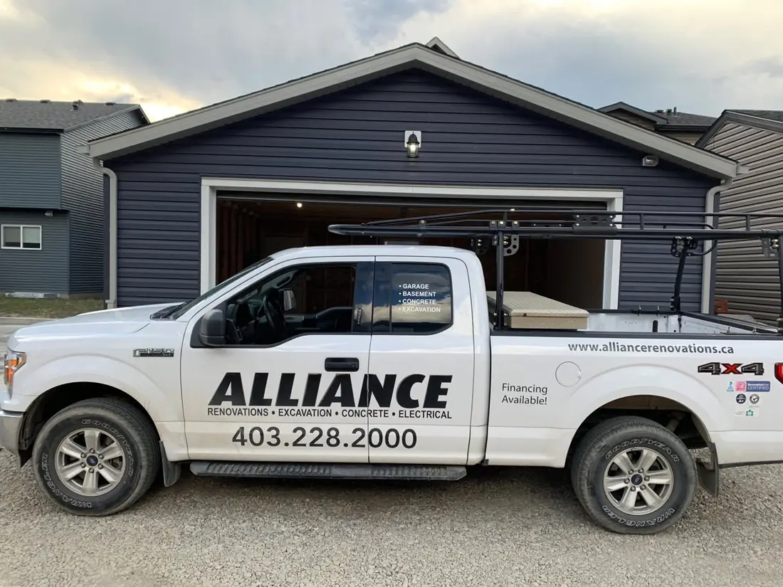 The Alliance Renovations truck parked in front of a navy garage it built