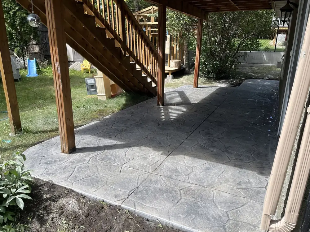 Stamped concrete under a deck, poured by Alliance