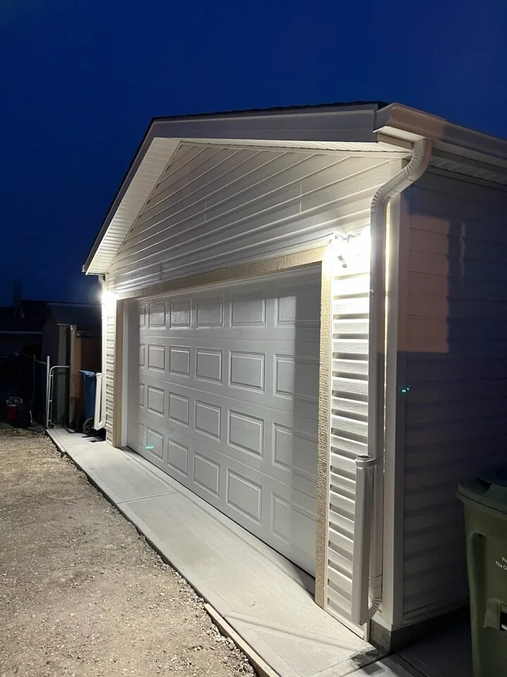 A light-sided garage lit up at night, built by Alliance